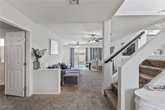 carpeted living room featuring ceiling fan