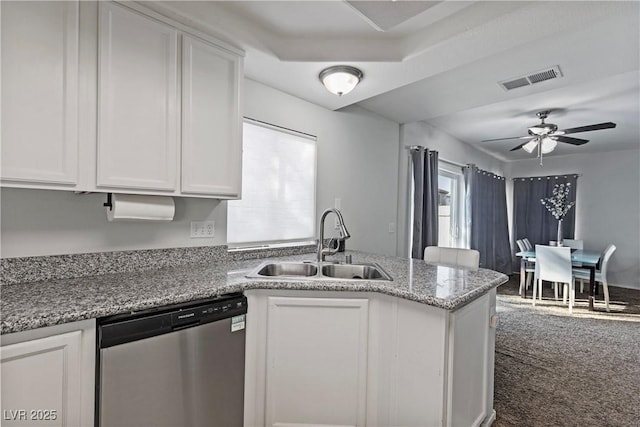 kitchen with sink, stainless steel dishwasher, white cabinets, and light stone countertops