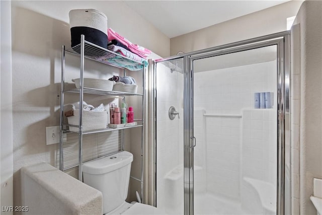 bathroom with walk in shower and toilet