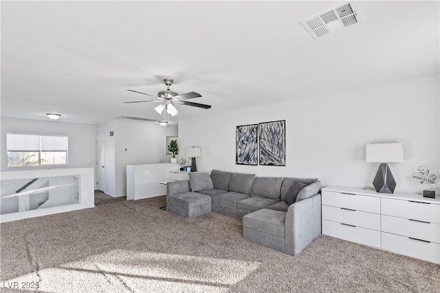 living room with ceiling fan and carpet floors