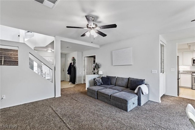 living room with ceiling fan and light carpet