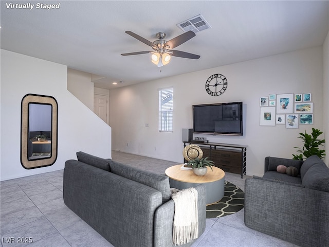 living room featuring light tile patterned floors and ceiling fan