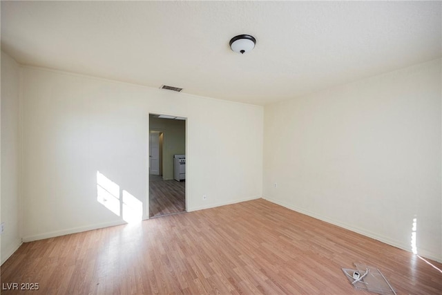 unfurnished room with light hardwood / wood-style floors