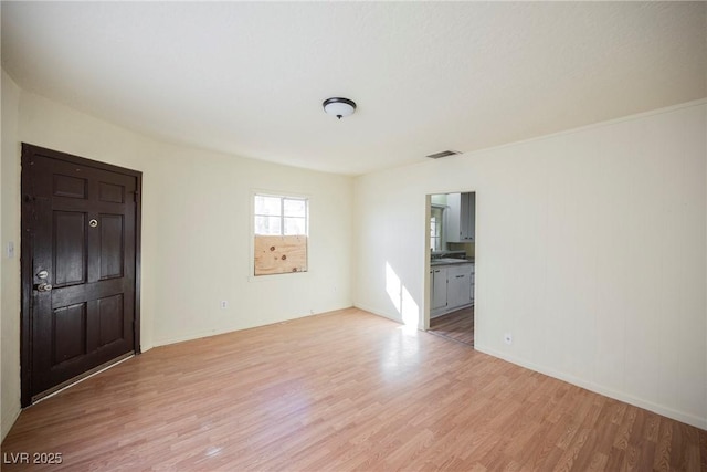 empty room with light hardwood / wood-style floors