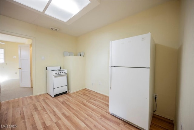 kitchen featuring white appliances and light hardwood / wood-style flooring