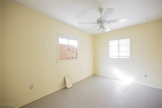 empty room featuring a healthy amount of sunlight and ceiling fan