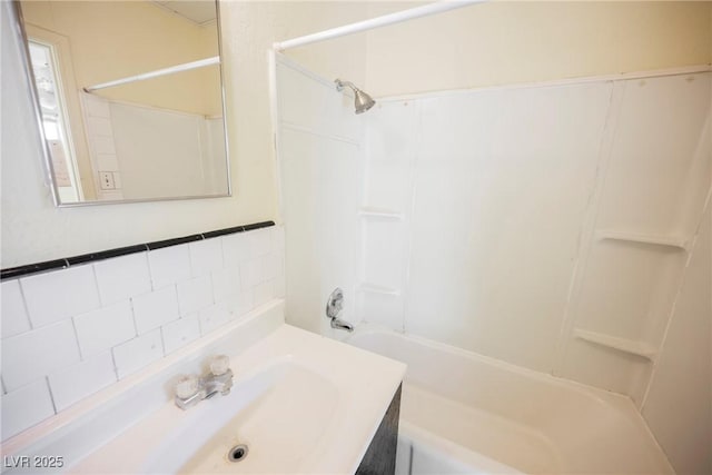 bathroom featuring bathing tub / shower combination and vanity