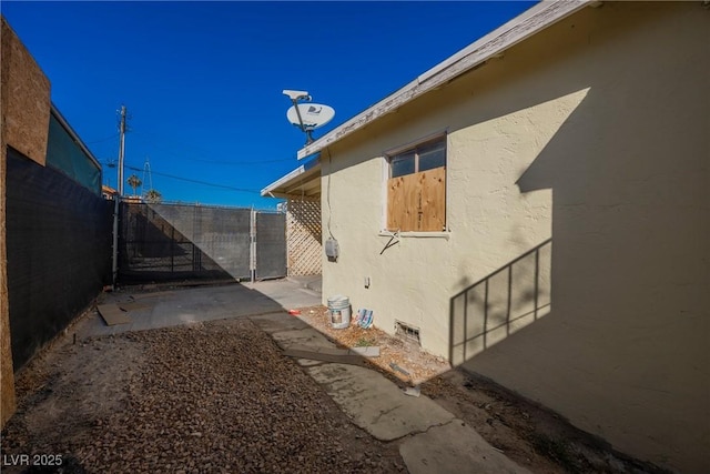 view of side of property featuring a patio area