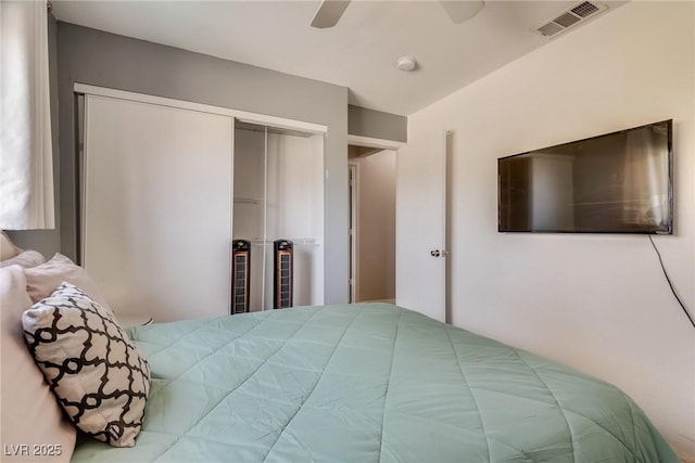 bedroom featuring ceiling fan and a closet