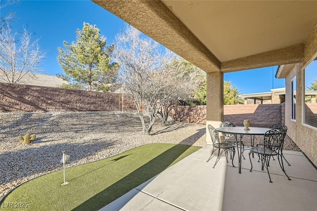 view of patio / terrace featuring outdoor dining space and a fenced backyard