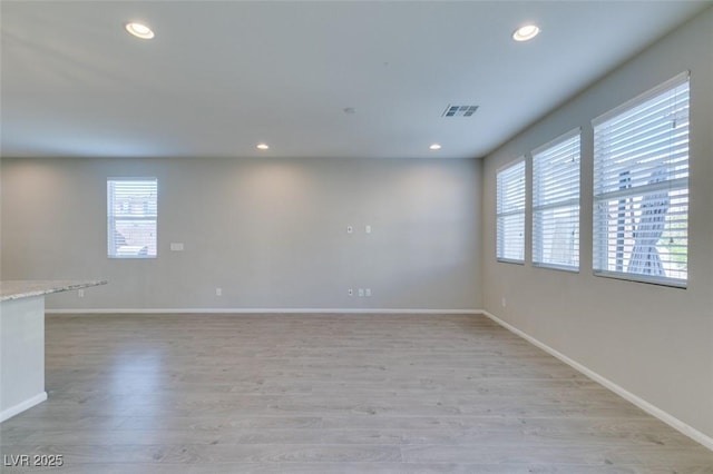 unfurnished room with light wood-type flooring