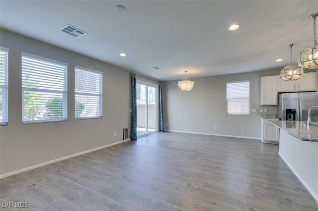 unfurnished living room featuring light hardwood / wood-style flooring