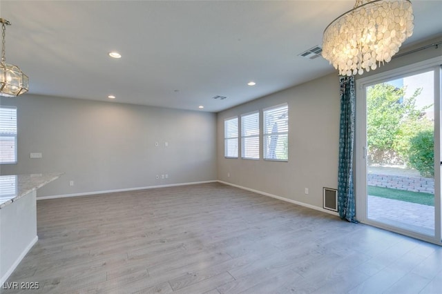 interior space with a chandelier and light hardwood / wood-style flooring