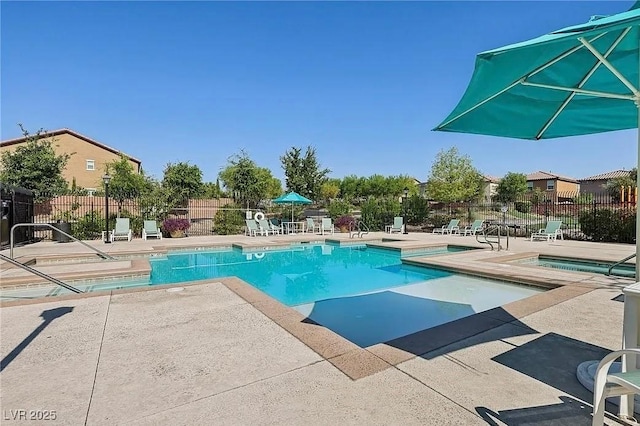 view of pool featuring a hot tub and a patio