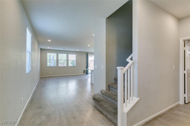 stairs featuring hardwood / wood-style floors