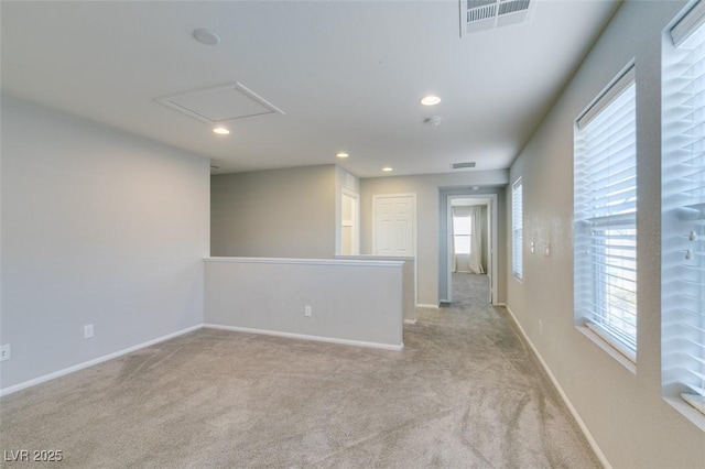 unfurnished room featuring light colored carpet