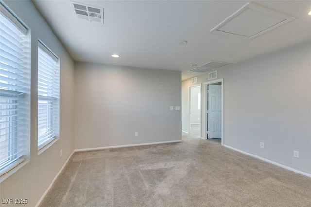 spare room featuring light colored carpet