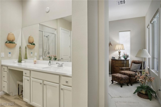 full bath with vanity, visible vents, and a stall shower