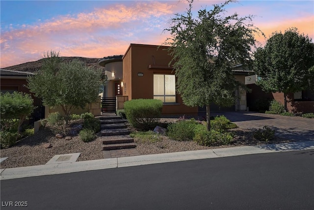 view of front of home featuring stucco siding and driveway