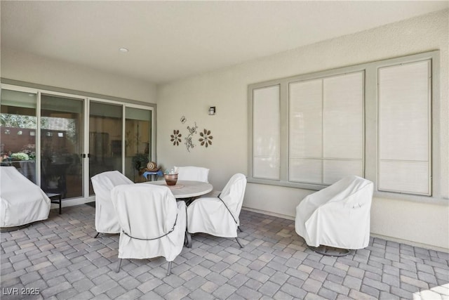 dining room with baseboards and brick floor