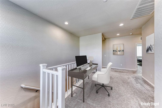 office space featuring carpet and a textured ceiling