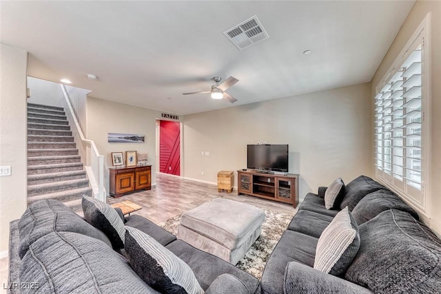 living room featuring ceiling fan and wood-type flooring