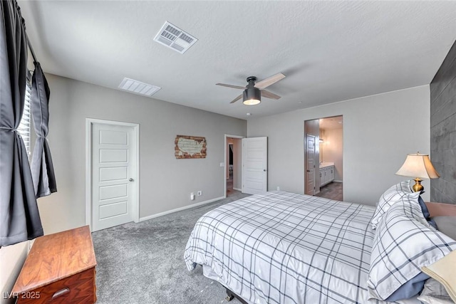 carpeted bedroom with ceiling fan, connected bathroom, and a textured ceiling