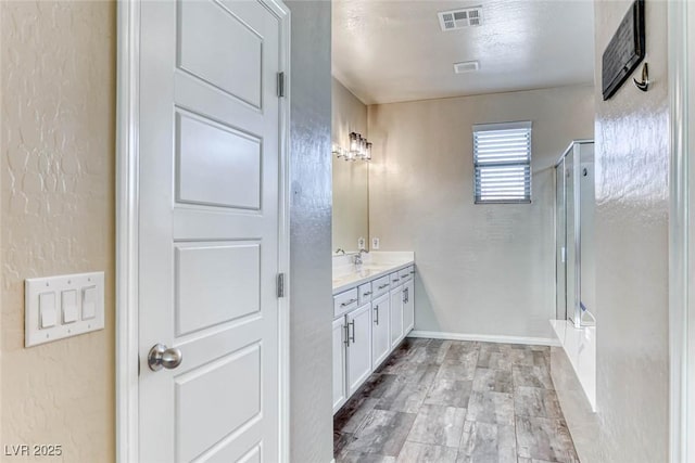 bathroom featuring vanity and an enclosed shower