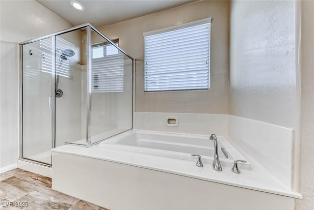 bathroom featuring separate shower and tub