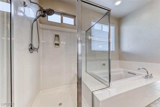 bathroom featuring independent shower and bath