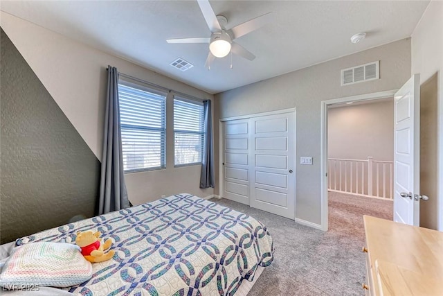 bedroom featuring light colored carpet, a closet, and ceiling fan