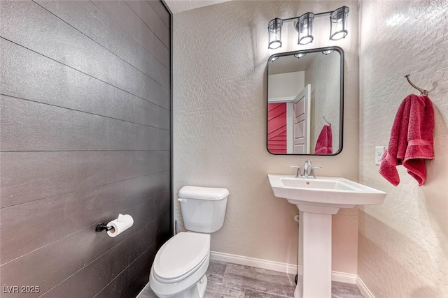 bathroom featuring hardwood / wood-style flooring, toilet, and sink