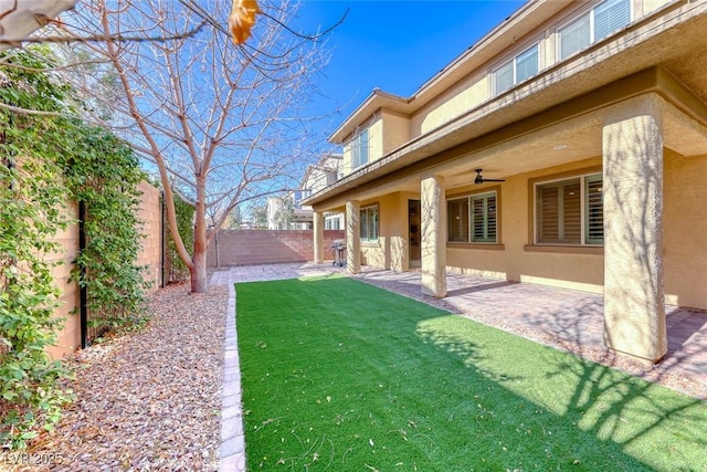 view of yard featuring ceiling fan and a patio area