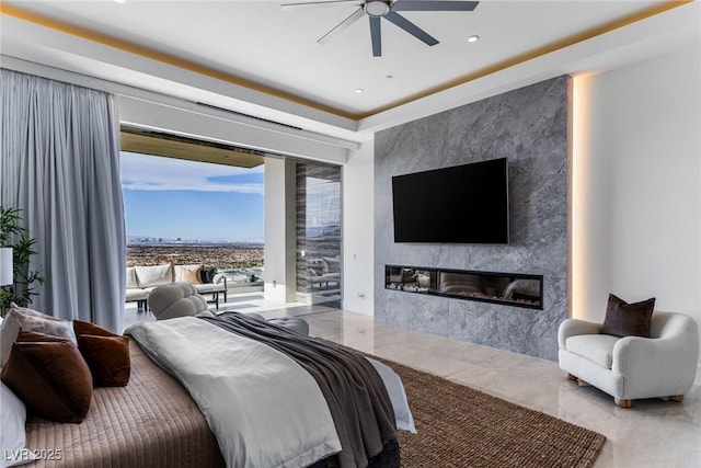 bedroom with a large fireplace, access to exterior, and ceiling fan