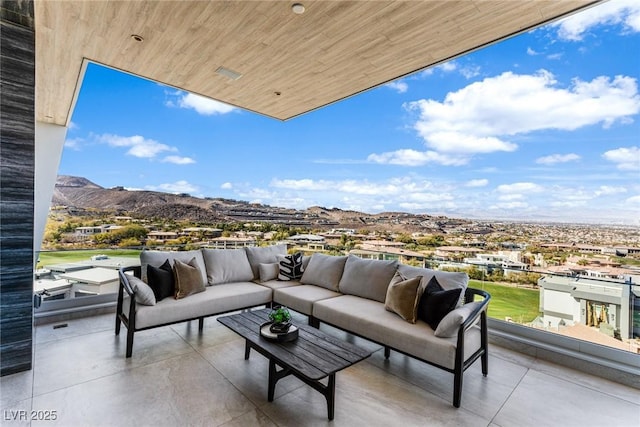 exterior space with a balcony, outdoor lounge area, and a mountain view