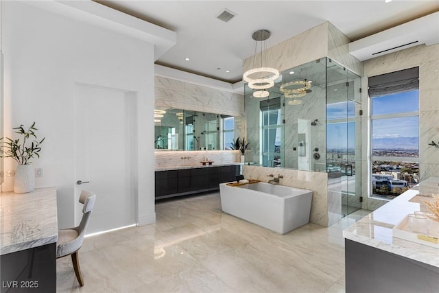 bathroom featuring vanity, shower with separate bathtub, and a chandelier