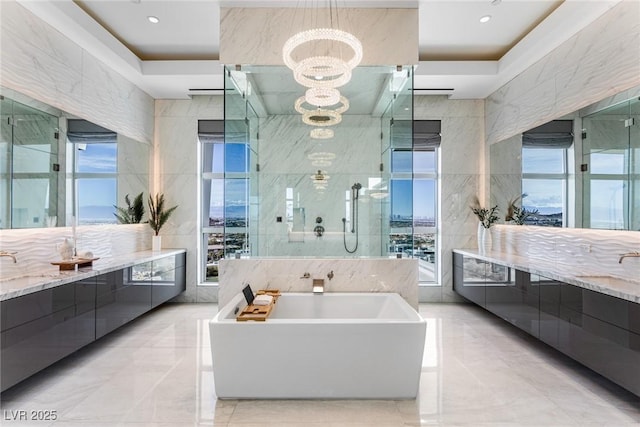 bathroom with separate shower and tub, a wealth of natural light, an inviting chandelier, and tile walls