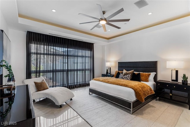 bedroom featuring a raised ceiling and ceiling fan