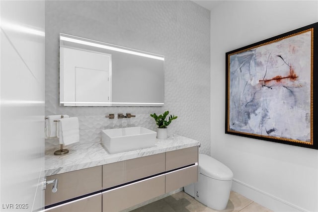 bathroom featuring vanity, tile patterned floors, and toilet