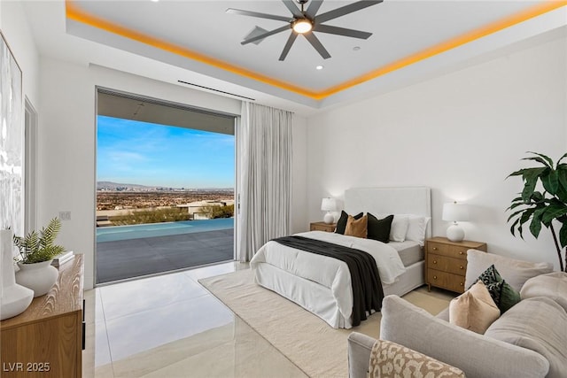 tiled bedroom featuring a raised ceiling and access to outside