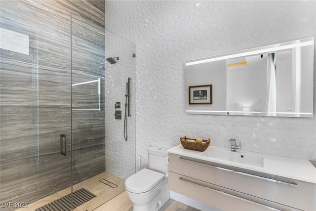 bathroom with walk in shower, vanity, and toilet