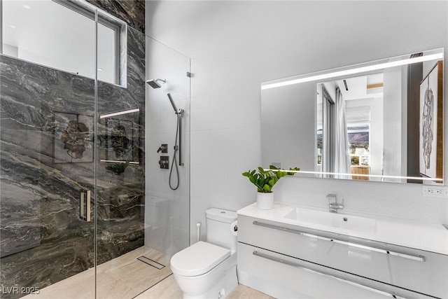 bathroom with vanity, an enclosed shower, and toilet