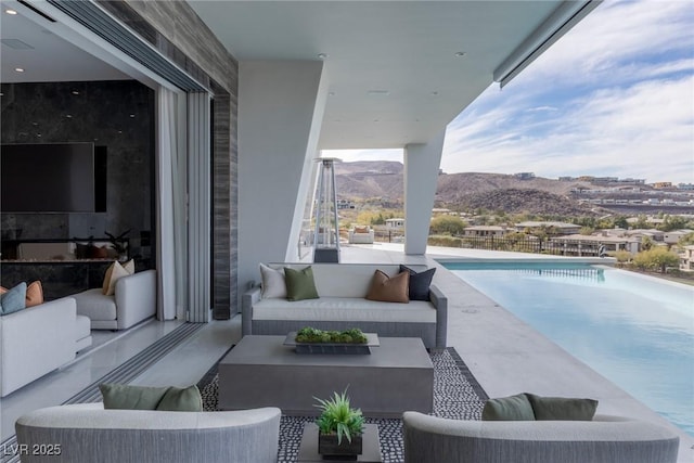 view of patio with an outdoor living space and a mountain view