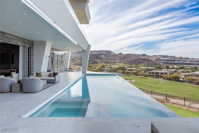 view of swimming pool featuring a mountain view and a patio