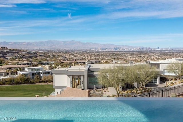 view of swimming pool with a water and mountain view