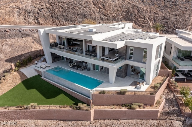 bird's eye view with a fenced in pool and a patio