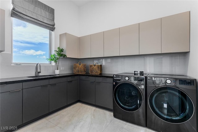 laundry area featuring cabinets, sink, and washer and dryer