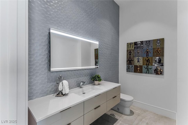 bathroom featuring vanity, tile patterned floors, and toilet