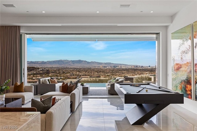 game room with a mountain view, plenty of natural light, and billiards