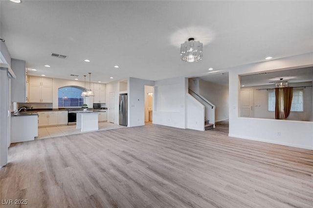 unfurnished living room with light hardwood / wood-style floors